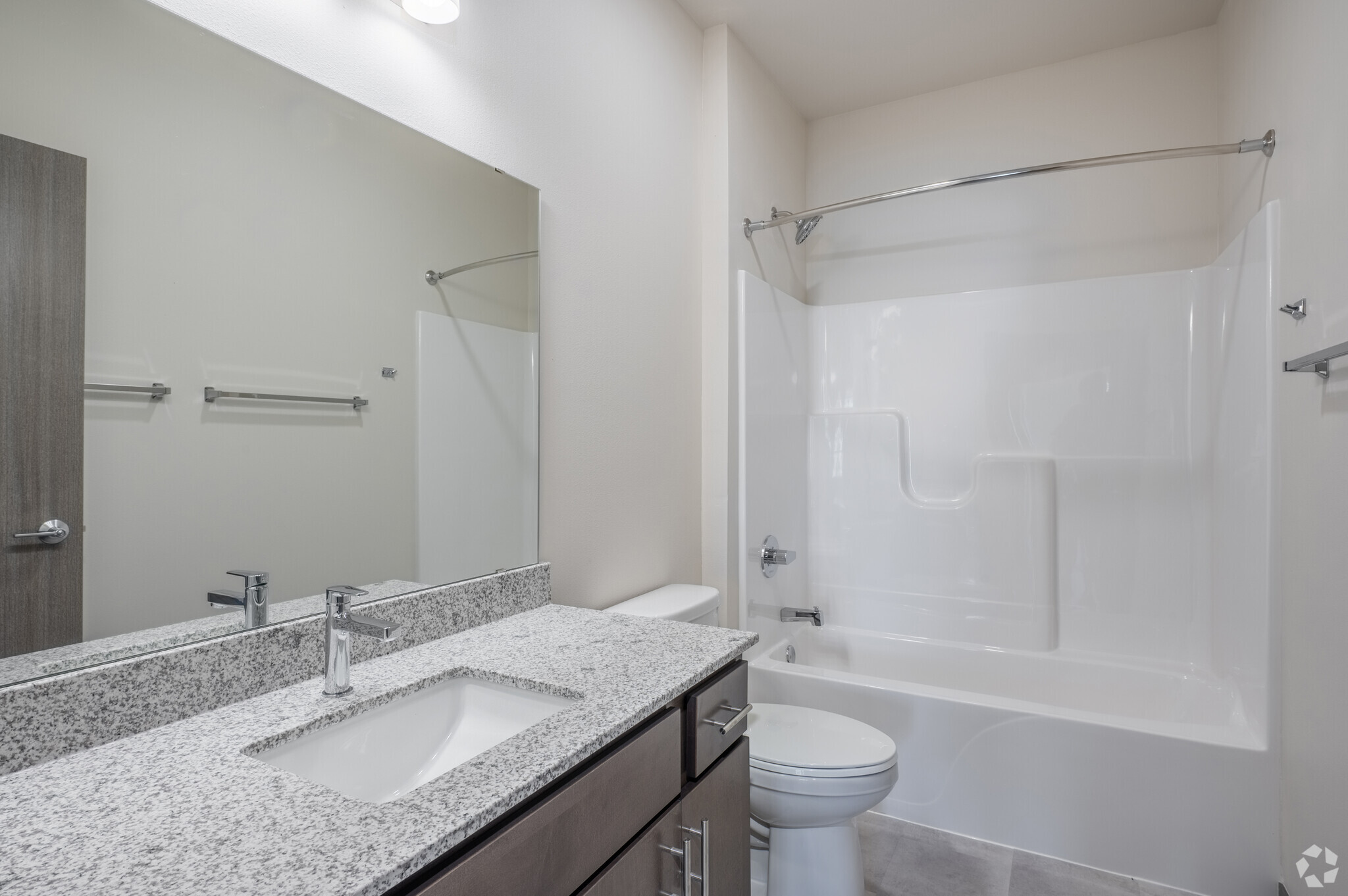 an empty apartment bathroom with shower and tub