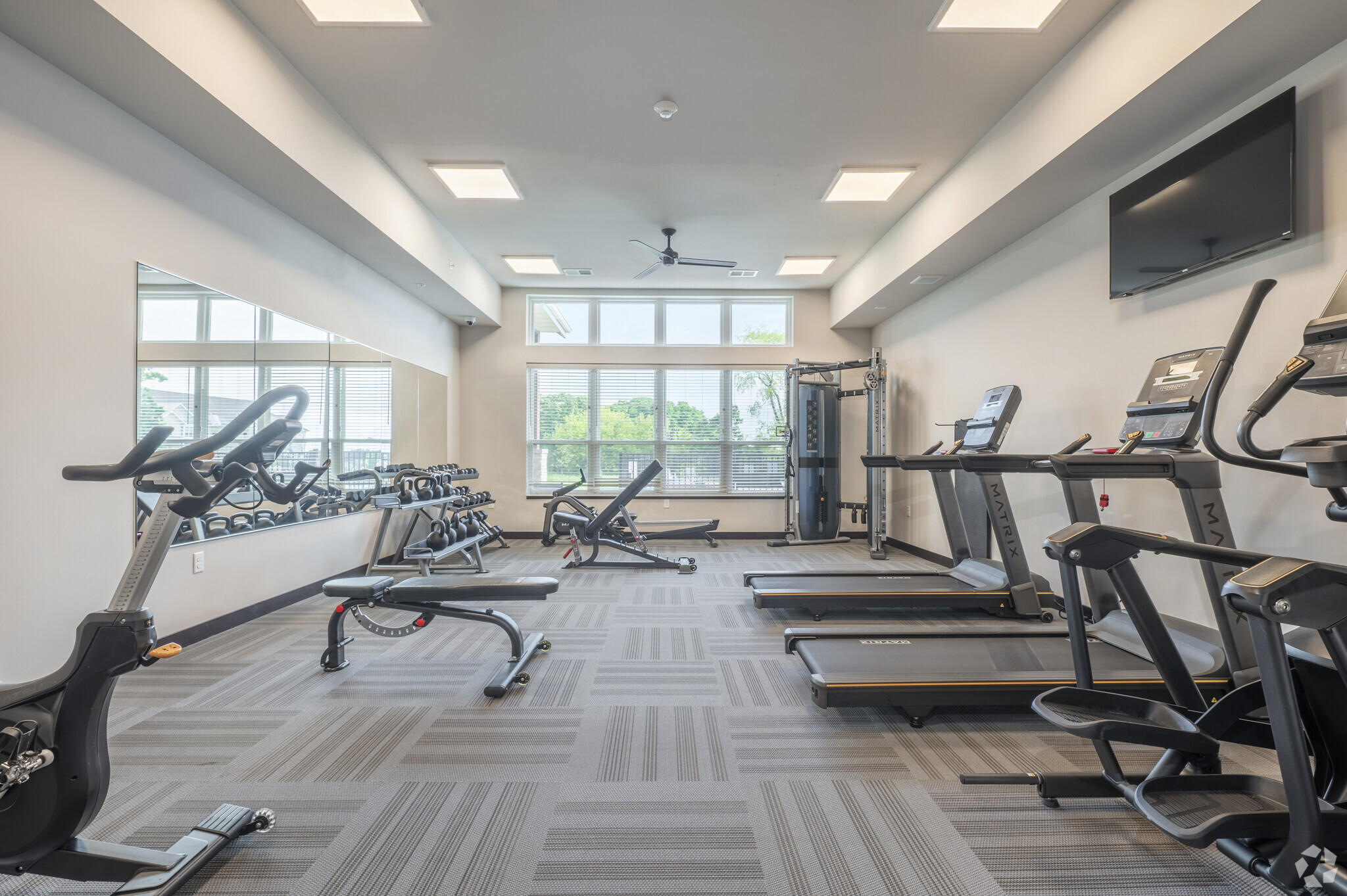 the fitness room at Irish Fields Apartments featuring exercise equipment